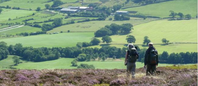 A couple enjoying the beautiful scenery on Wainwright's Coast to Coast | John Millen