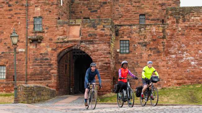 Cyclists riding near Carlisle Castle | Carlos Reina