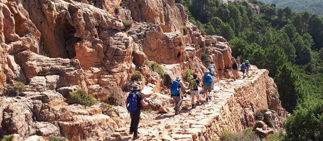 The sun shining down a group in mountainous Corsica | Paul Ensor