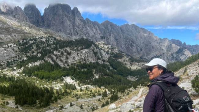 Hiker taking in the view in the Ropojana Valley Albania | Kate Baker