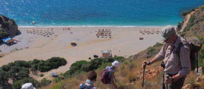 Hikers descending to a beach on Albania's Riviera