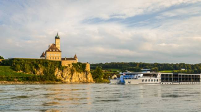 Barge crossing by Schonbuhel Castle on the Danube river